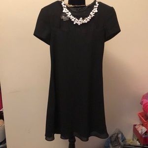 Black Mini Dress with sheer neckline.